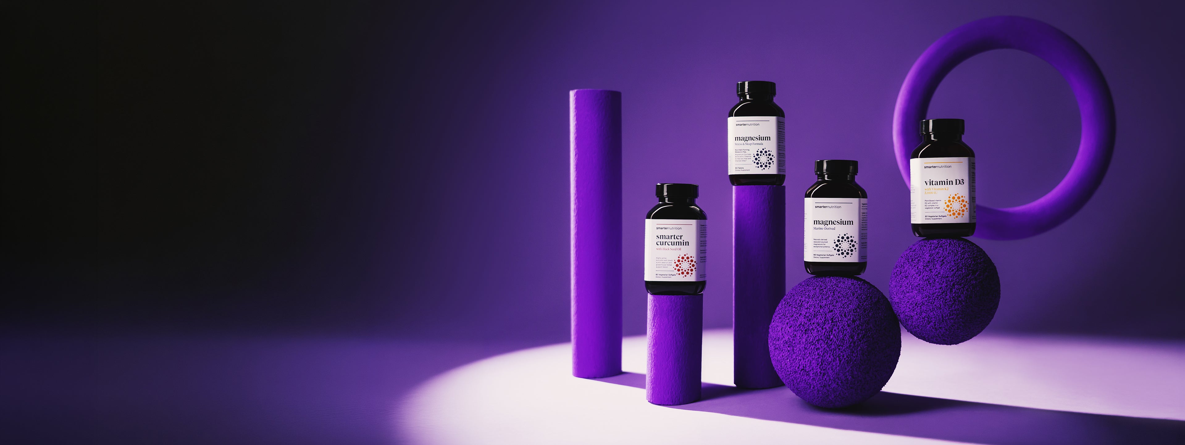 Smarter Nutrition Best Seller Supplement bottles on a dark purple background
