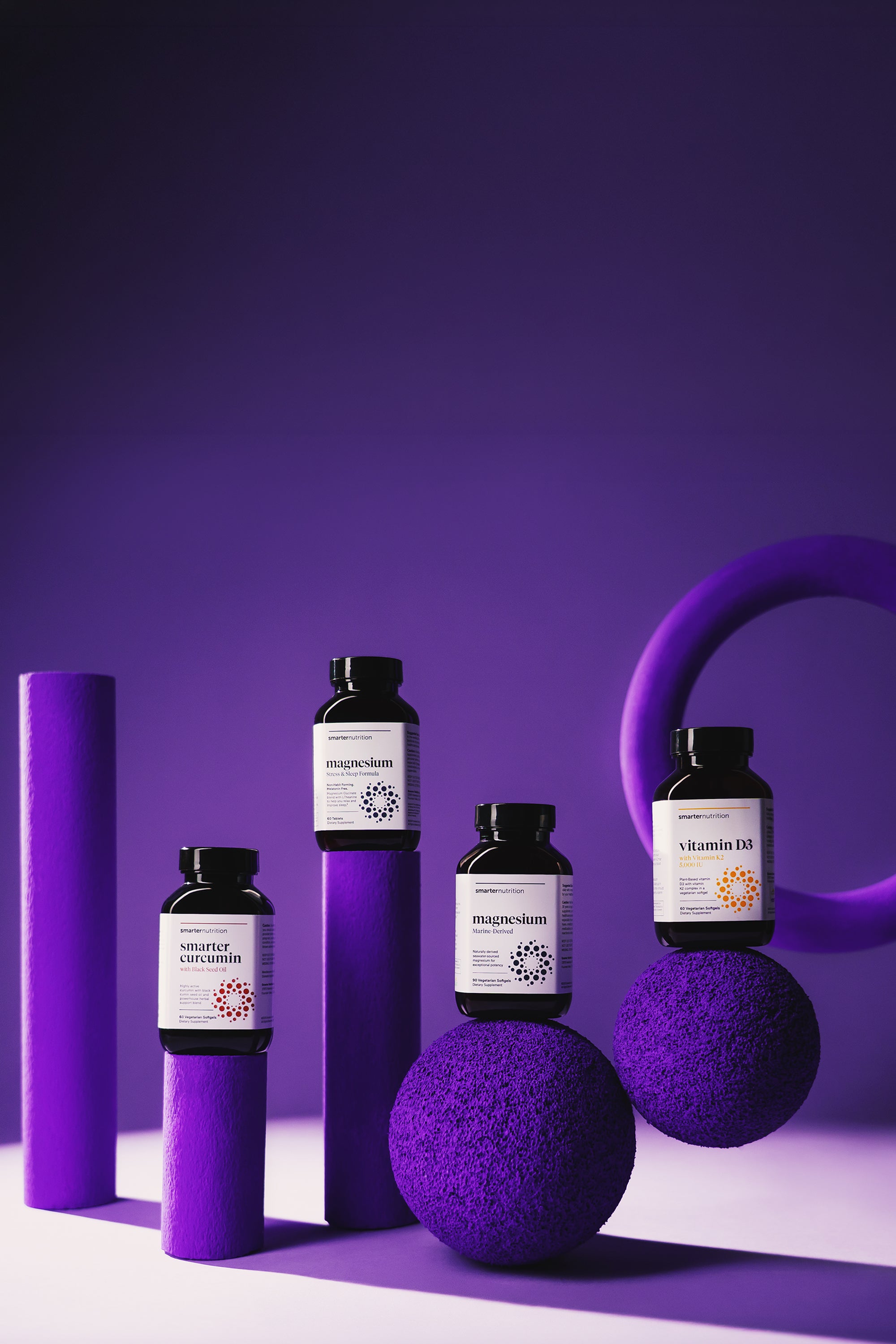 Smarter Nutrition Best Seller Supplement bottles on a dark purple background